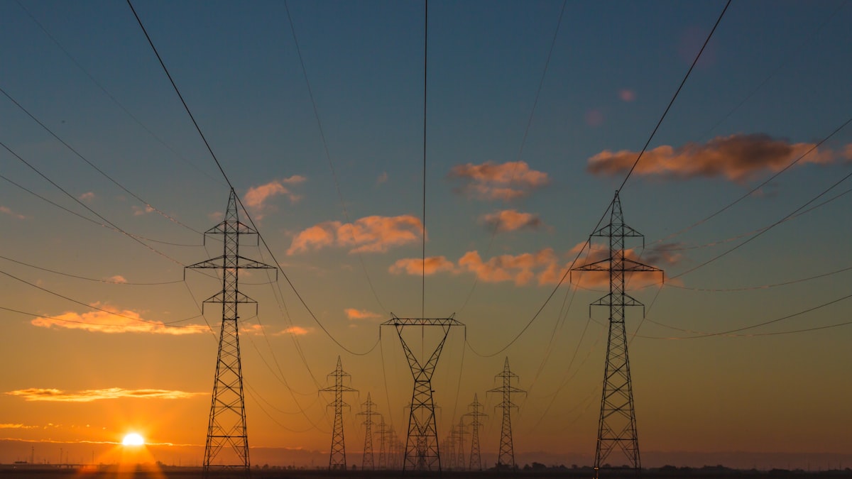Wind turbines at sunset representing the clean energy transition