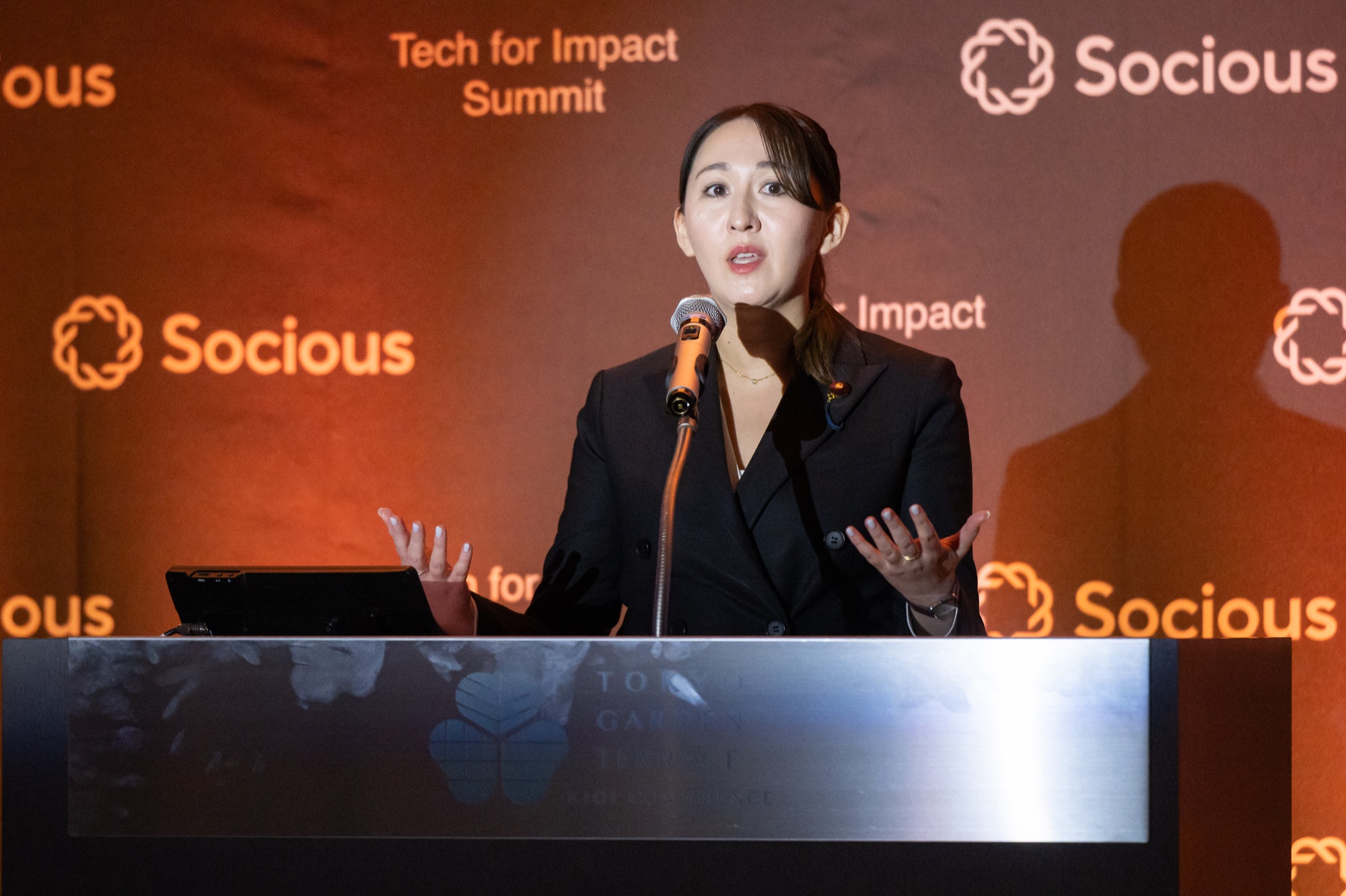 Vice Minister Arfiya gestures to the closing-session audience at Tech for Impact Summit 2026